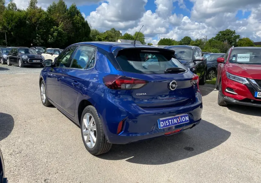 Opel Corsa bleu nautique vue 3/4 arrière droit, avec jantes alliage 16'' et caméra de recul visible.