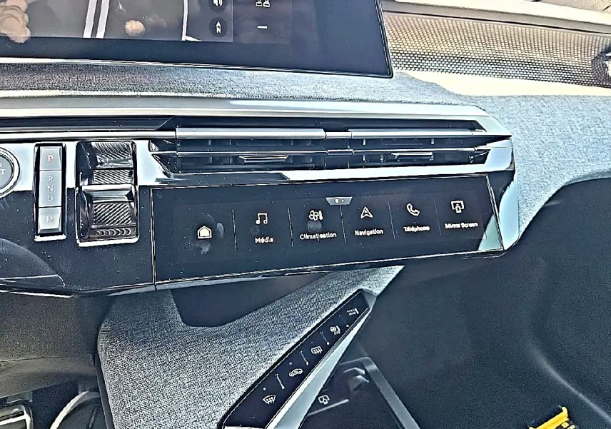 Détail de la console centrale noire du Peugeot 3008 1.2 hybrid 145 GT, avec écran tactile et commandes tactiles.