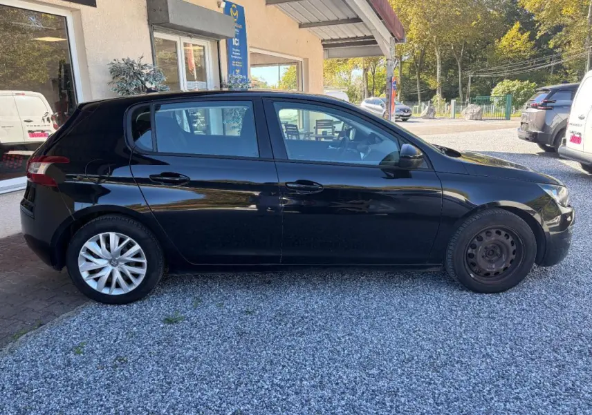 Peugeot 308 Active noire vue de profil côté gauche, avec jante alliage arrière et roue acier avant.