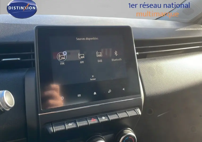Écran tactile central de la Renault Clio blanc glacier 2021 affichant les sources audio FM, AM, DAB et Bluetooth.