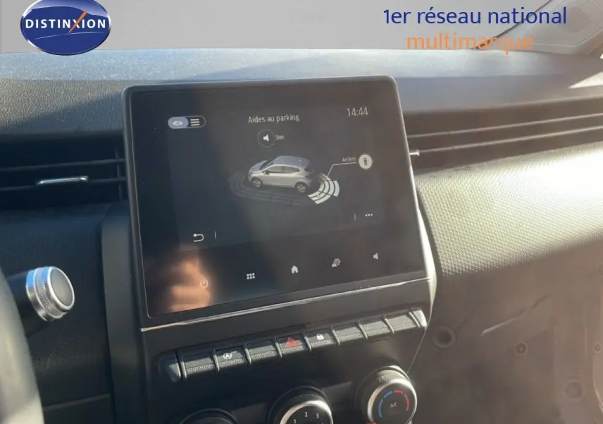 Écran tactile central affichant l'aide au parking dans l'habitacle d'une Renault Clio blanche glacier de 2021.