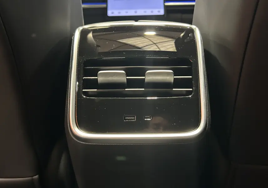 Vue rapprochée de la console arrière noire avec bouches d’aération et ports USB du JAECOO J7 TGDI PHEV 2026.