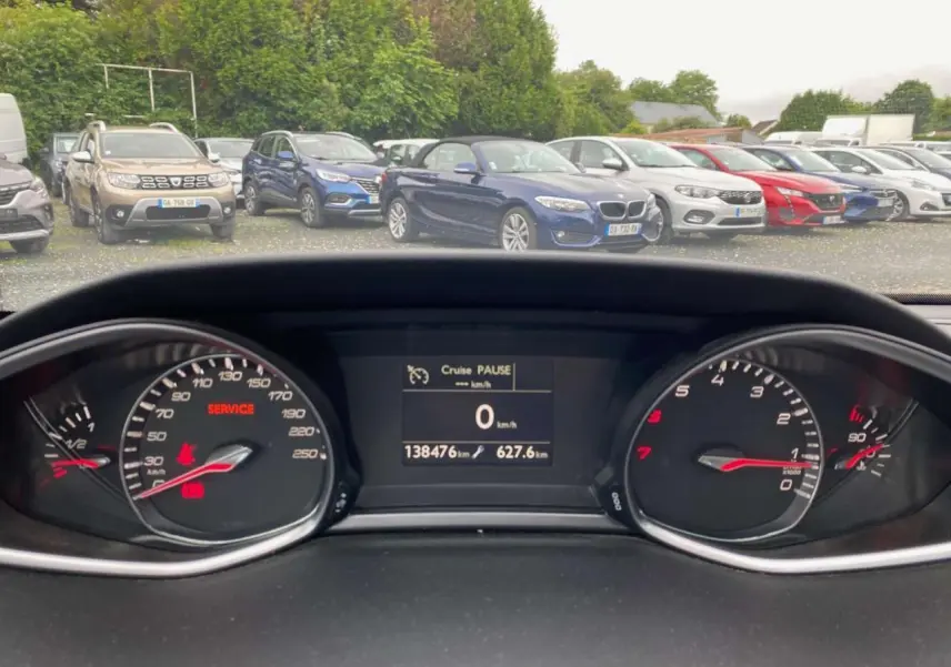 Vue intérieure du tableau de bord de la Peugeot 308 SW bleu magnétique, affichant le compteur et l'écran digital au repos.