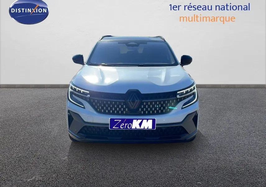 Vue frontale d'un Renault Espace blanc nacré 2025 avec calandre noire et feux LED distinctifs allumés.