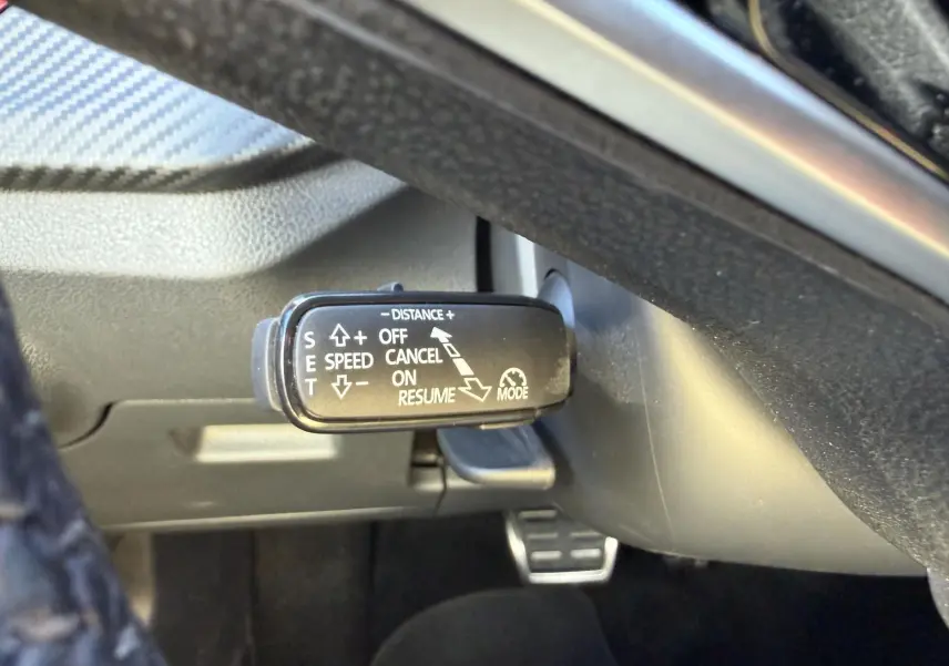 Gros plan sur la commande du régulateur de vitesse adaptatif sous le volant du Skoda Kamiq 2025.