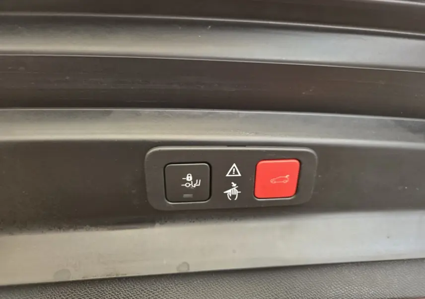 Boutons de commande du coffre électrique sur panneau intérieur gris foncé d’un Peugeot 5008 2020.