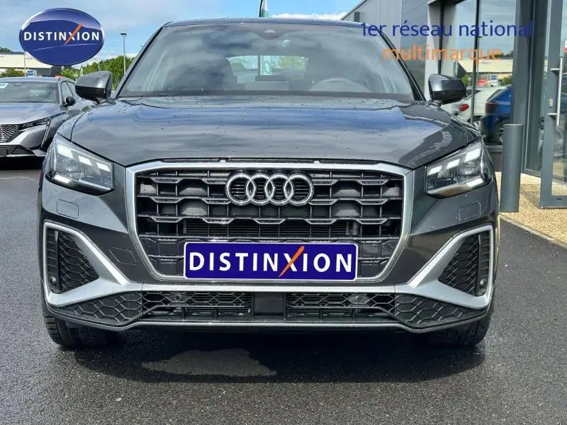 Vue frontale d'un Audi Q2 30 TDI S line gris Daytona nacré avec calandre noire et phares LED marqués
