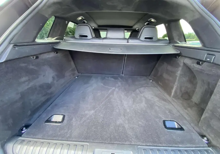 Vue intérieure du coffre spacieux et noir du Range Rover Sport SVR 2016 avec cache-bagages déployé.