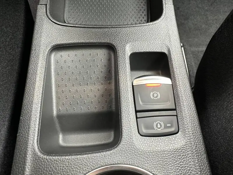 Vue rapprochée de la console centrale du Renault Captur 2026 gris Rafale, montrant les boutons de frein à main et auto hold.