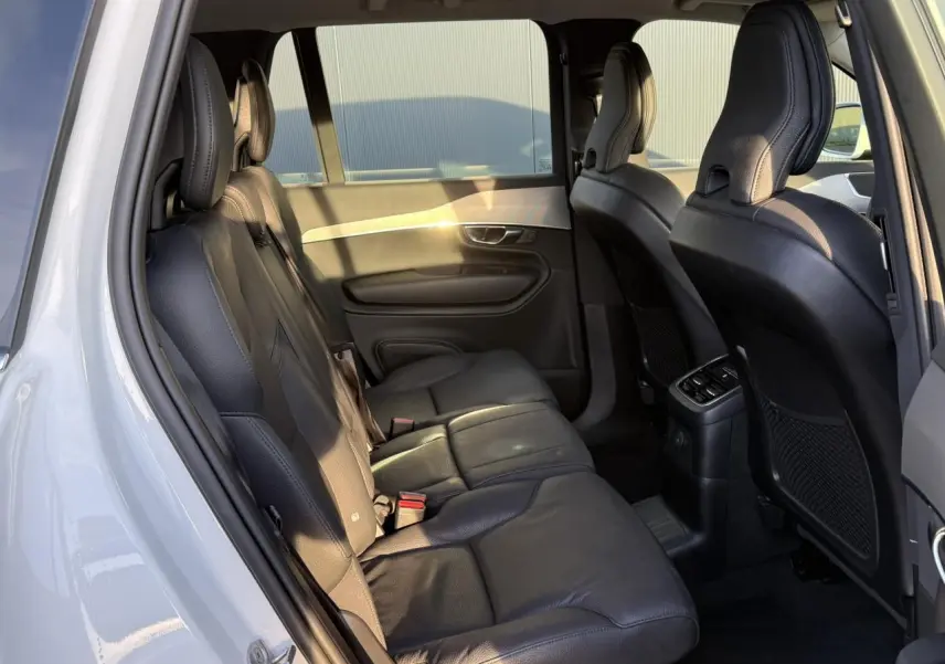 Vue intérieure côté gauche sur la banquette arrière en cuir noir du Volvo XC90 blanc Crystal 2024.
