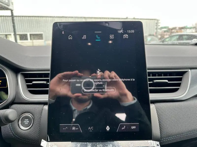 Écran tactile central du Renault Captur 2026 en hybride gris Cassiopée/Noir Étoilé, affichant la connexion Bluetooth.