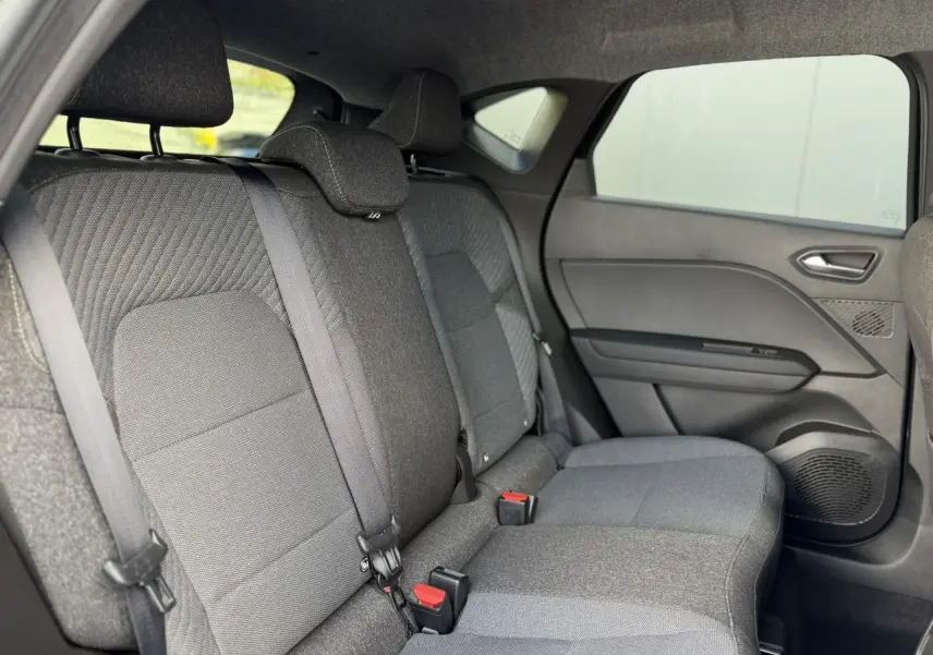 Vue latérale droite des sièges arrière gris foncé du Renault Captur 2026 avec ceinture de sécurité et garnitures de porte.