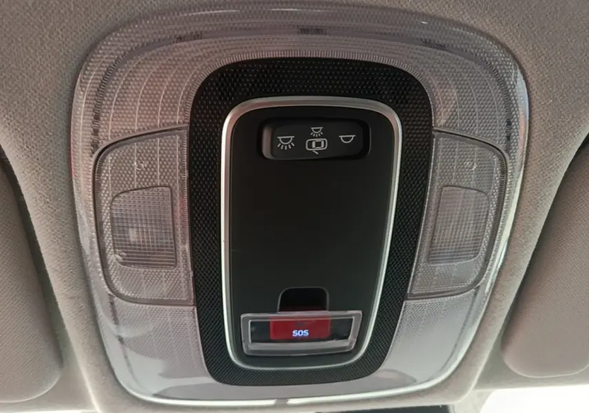Gros plan sur la console de toit gris clair avec bouton SOS rouge et commandes d’éclairage dans une Hyundai Bayon 2023.