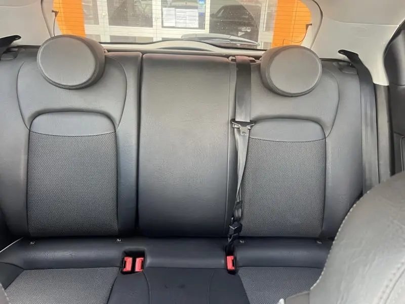 Vue arrière intérieure montrant la banquette arrière noire en cuir et tissu du Fiat 500X 2015.