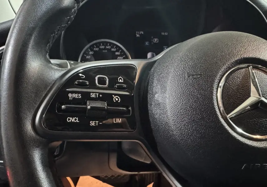 Gros plan sur le volant cuir noir de la Mercedes Classe C Break C 200 d Business Line avec commandes multifonctions.