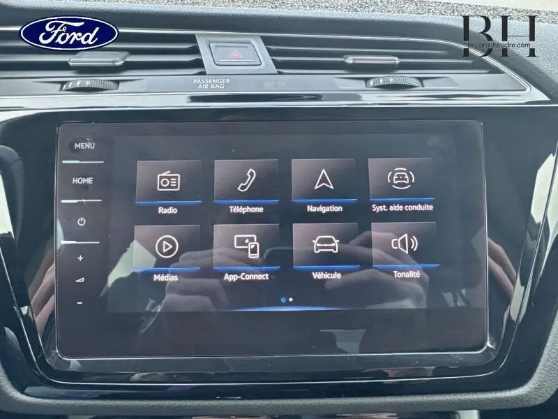 Écran tactile central du tableau de bord du Volkswagen Touran 2021 en Reflet d'Argent Métallisée, affichant les options multimédia.