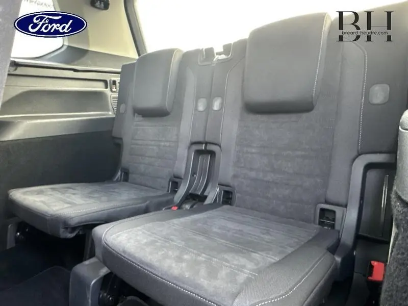 Vue intérieure sur les sièges de la 3ème rangée noirs du Volkswagen Touran 1.5 TSI Carat 2021, finition tissu.