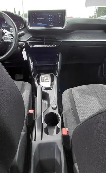 Vue intérieure centrée sur la console centrale et tableau de bord du Peugeot 2008 Hybrid 145 e-DCS6 Style noir 2025.