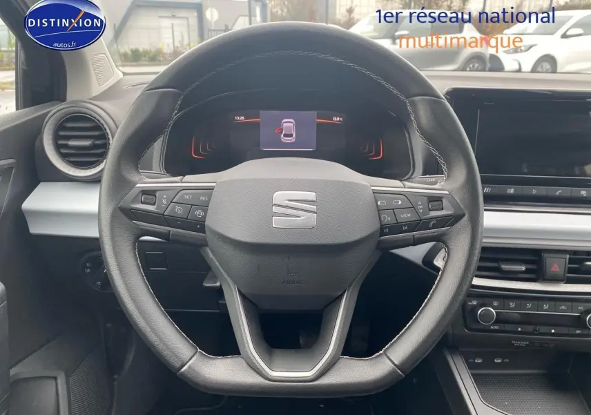 Vue frontale du volant en cuir noir de la SEAT Ibiza 2025, avec tableau de bord digital et commandes intégrées.