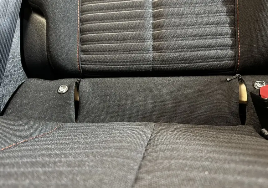 Gros plan sur la banquette arrière noire avec coutures rouges de la Peugeot 208 Electrique Active Business.