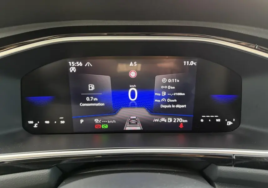 Vue rapprochée du tableau de bord digital du Volkswagen T-Roc 2025 affichant la consommation et la vitesse à 0 km/h.