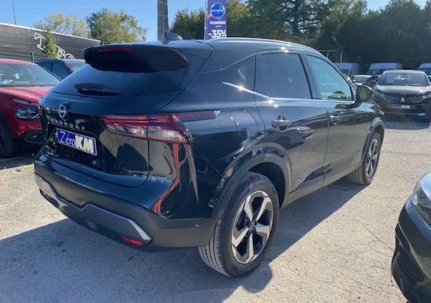 Vue 3/4 arrière droite d'un Nissan Qashqai noir 2023 avec jantes alliage et feux arrière LED distinctifs.