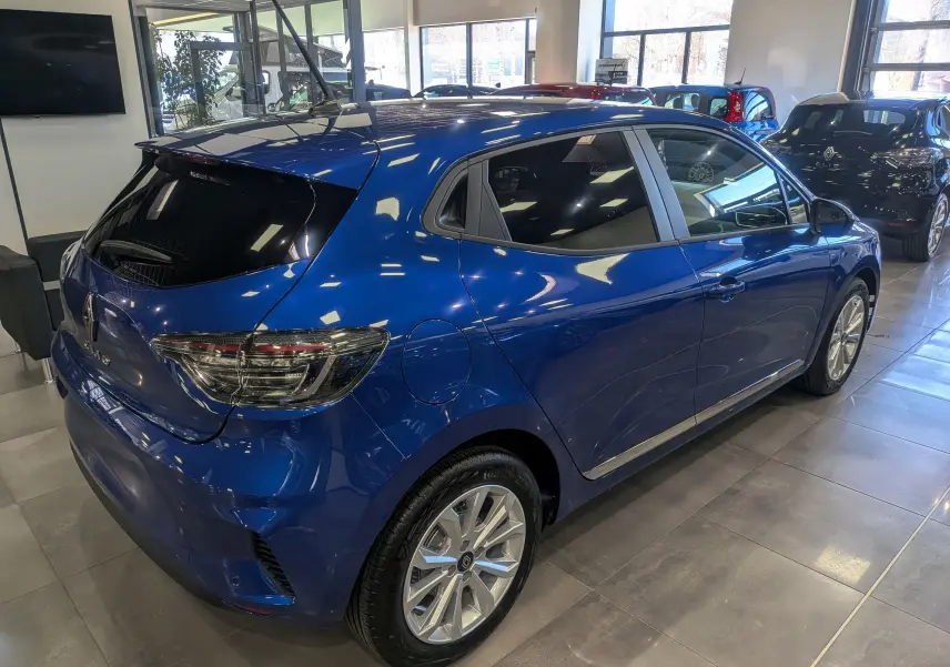 Renault Clio V Blue dCi 100 en bleu Iron, vue 3/4 arrière droit, vitres teintées et jantes alliage 16 pouces.