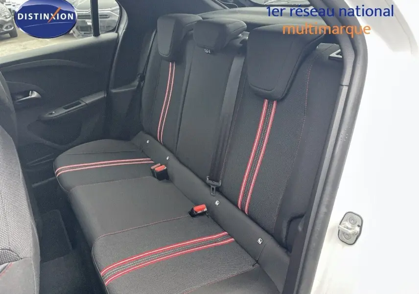 Vue intérieure côté droit des sièges arrière noirs avec surpiqûres rouges d'une Opel Corsa blanche 2022.