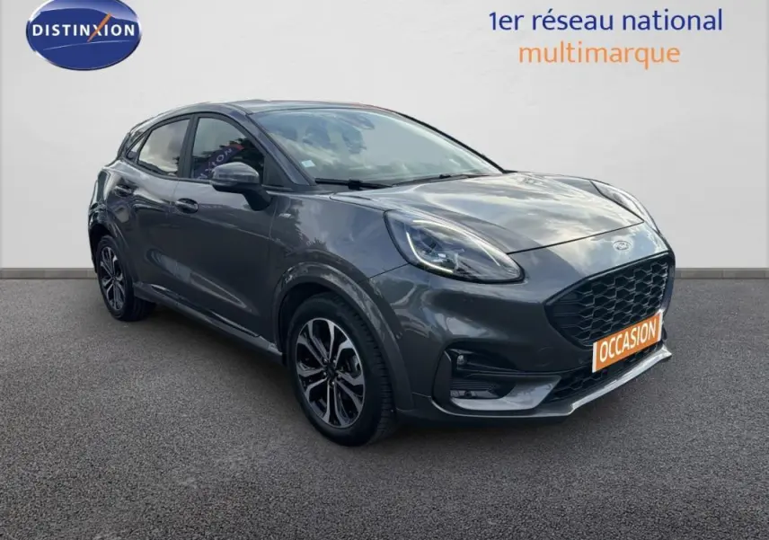 Ford Puma gris foncé vue 3/4 avant droit avec jantes alliage noires et calandre large noire.