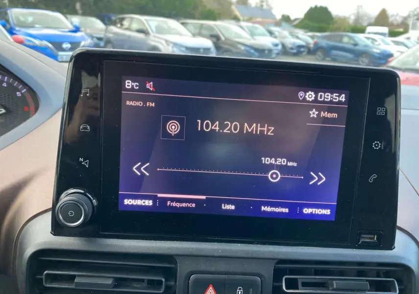 Écran tactile central de la Peugeot Rifter GT bleu, affichant la radio FM à 104,20 MHz, vue intérieure.