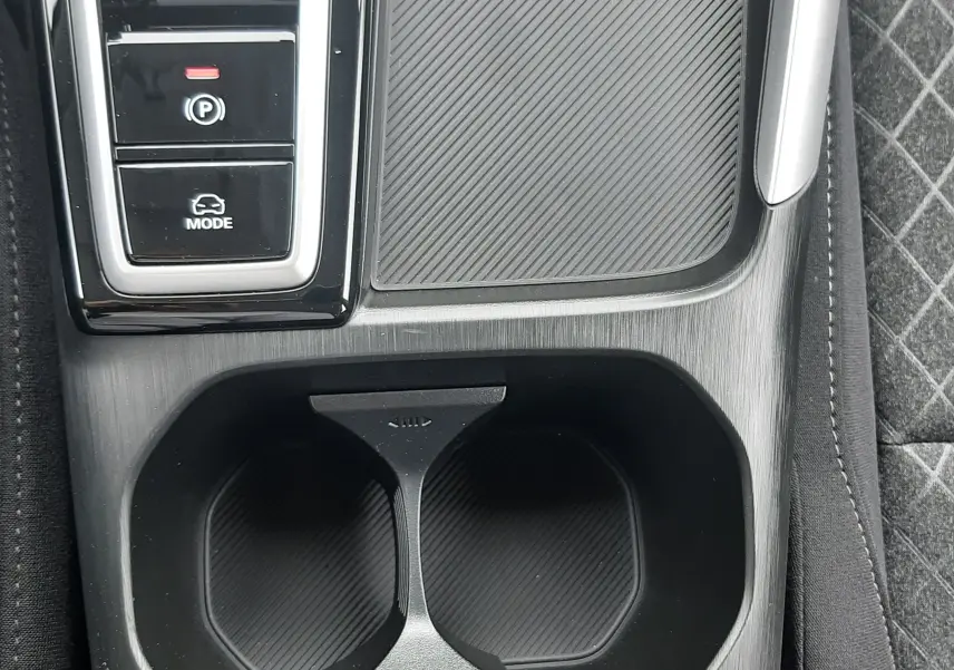 Gros plan sur la console centrale noire du MG ZS Camden Grey 2026, avec porte-gobelets et boutons de mode de conduite.