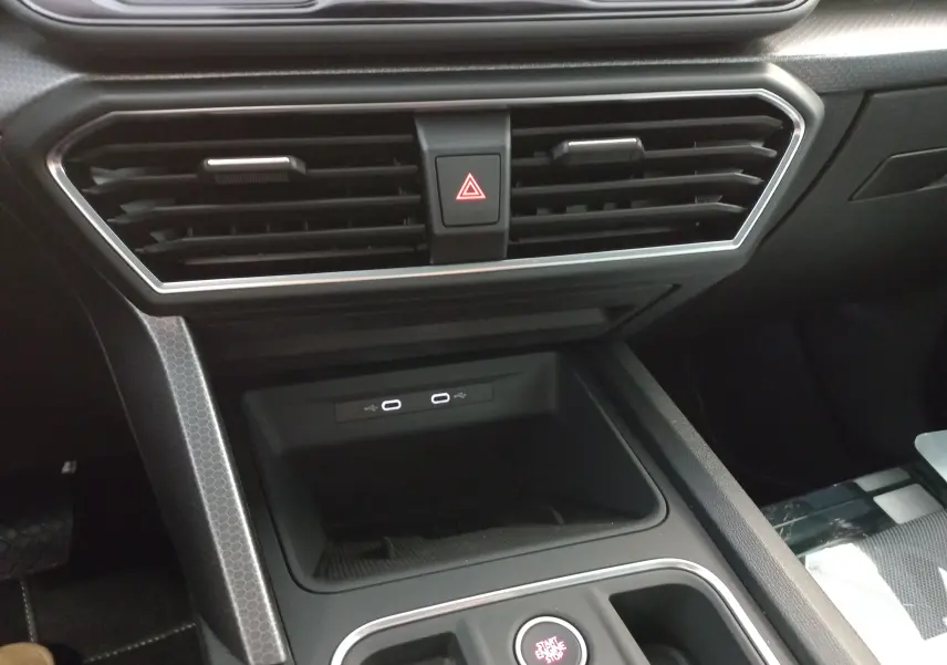 Intérieur SEAT Leon 1.5 eTSI 2025, vue centrale sur la console avec prises USB-C et bouton start/stop, finition noire.