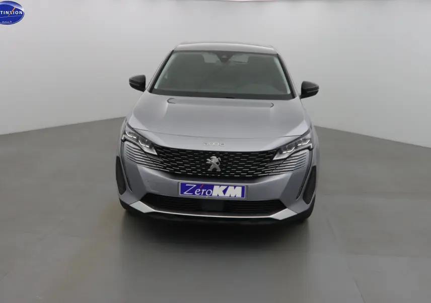 Vue frontale d'un Peugeot 3008 gris Artense métal avec calandre noire et plaque "Zero KM" visible.
