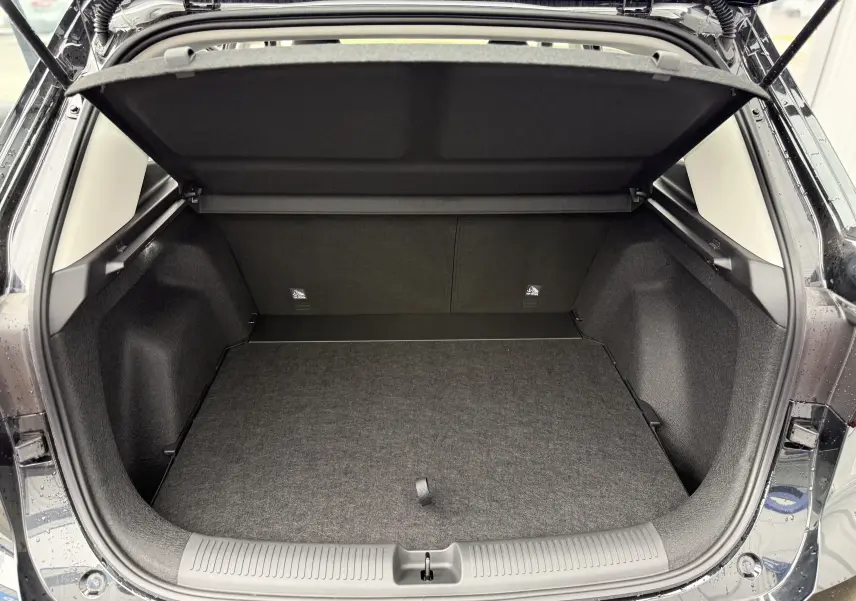 Vue arrière du coffre ouvert du MG ZS 1.5L Hybrid+ 197CH en gris Hampstead, montrant un espace de chargement propre et spacieux.
