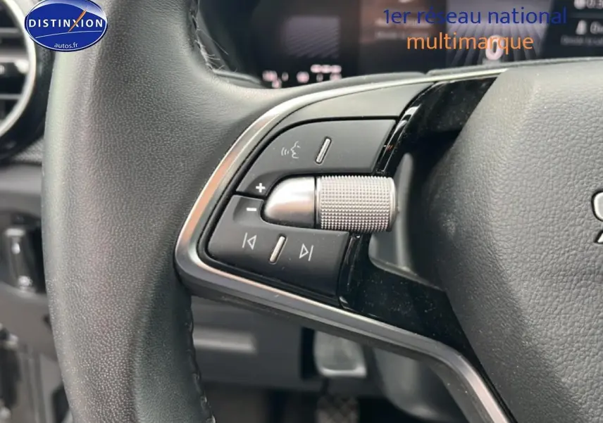 Gros plan sur les commandes multifonctions côté gauche du volant cuir de la Skoda Fabia noire 2025.