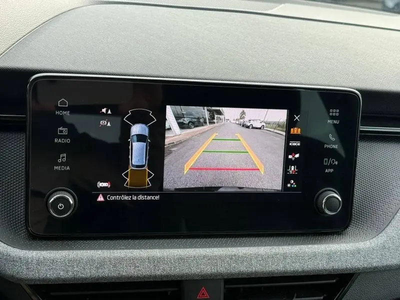 Écran central du Skoda Kamiq 2024 montrant la caméra de recul avec guidage couleur et vue 360° du véhicule noir nacré.