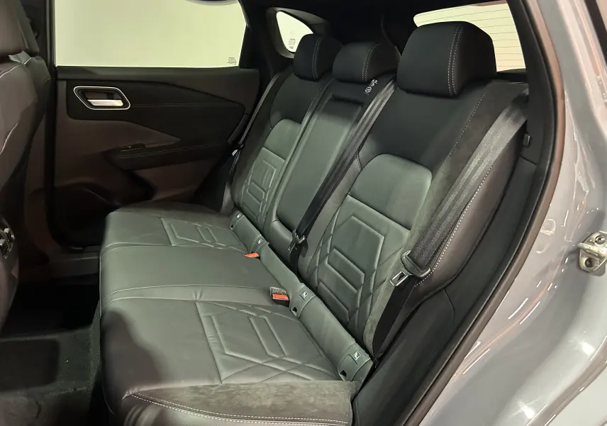 Vue côté gauche de la banquette arrière en cuir noir du Nissan Qashqai 2025 gris céramique avec porte ouverte.