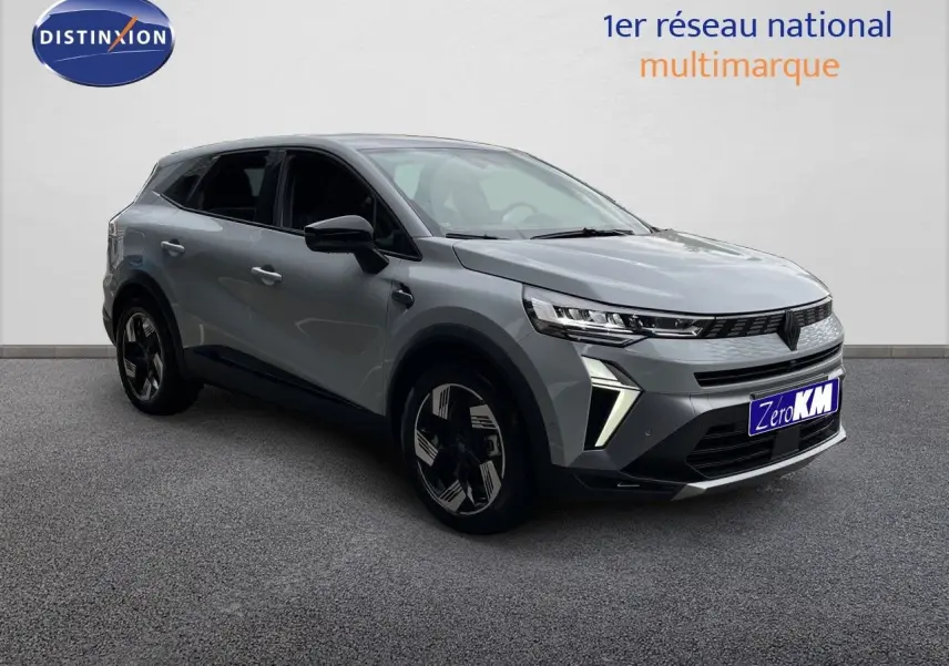 Renault Symbioz gris Rafale métal en 3/4 avant droit, SUV hybride avec feux LED et jantes bicolores distinctives.