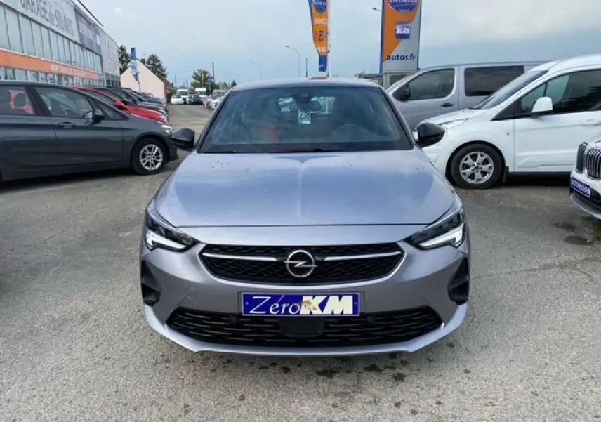 Vue frontale d'une Opel Corsa 1.2i Turbo gris magnetic 2022 avec calandre noire et phares LED allumés.