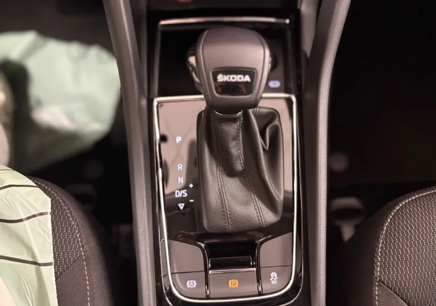 Le levier de vitesses automatique SKODA KODIAQ 2.0 TDI en cuir noir vu de dessus avec commandes éclairées.