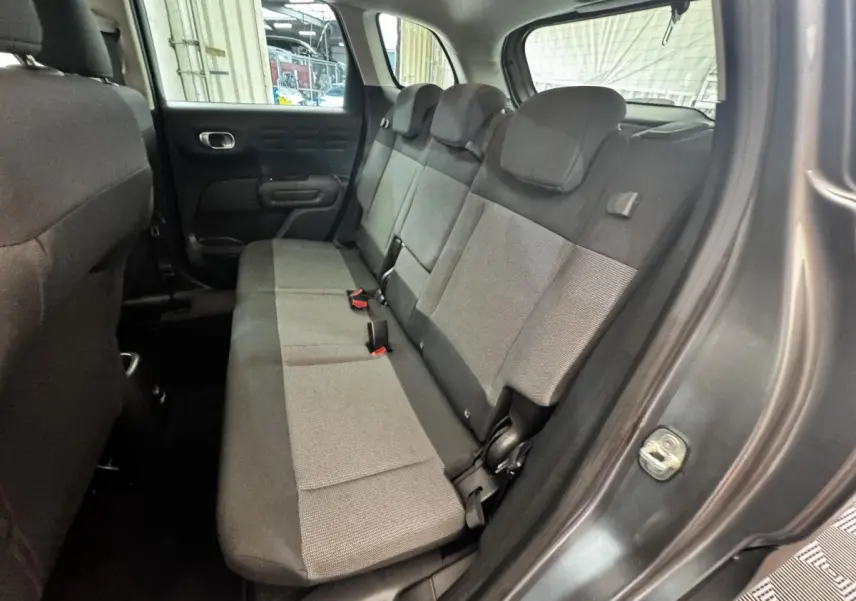 Vue intérieure côté droit montrant la banquette arrière grise et noire de la Citroën C3 PureTech 110 Shine 2019.