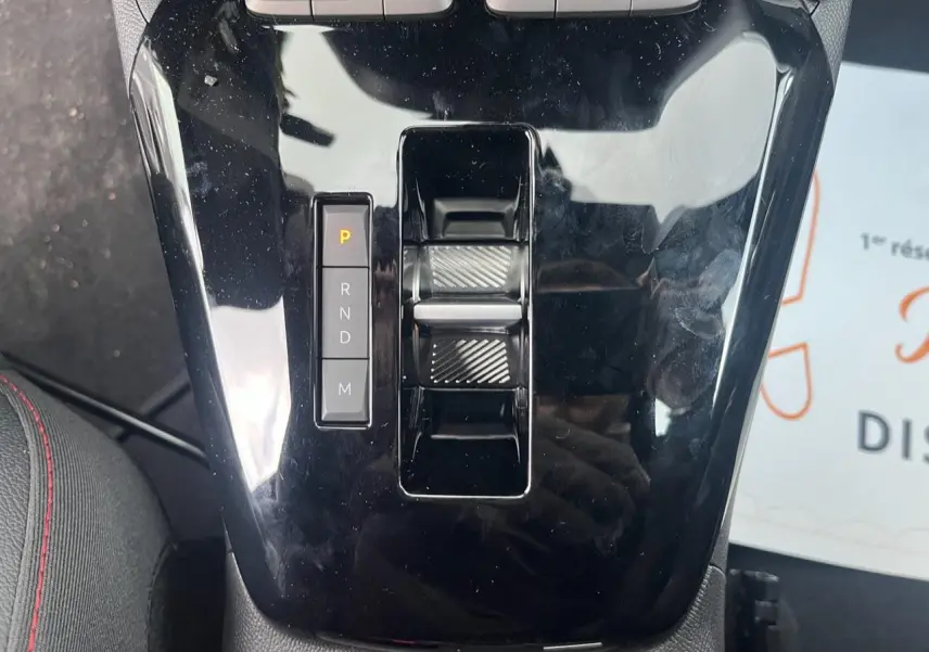 Gros plan sur la console centrale noire brillante de l'Opel Corsa GS Line 2022 avec sélecteur de boîte automatique.