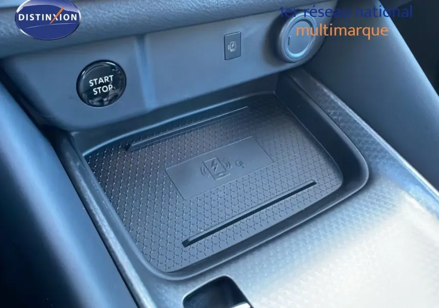 Détail de la console centrale avec zone de recharge sans fil et bouton start/stop du Nissan Qashqai 2025 gris argile métal.