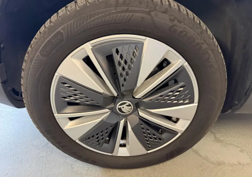 Gros plan sur la jante alu 17 pouces bicolore et le pneu Goodyear du Skoda Karoq bleu 2023 côté gauche.