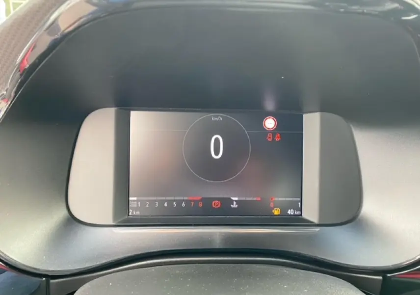 Tableau de bord numérique de l'Opel Corsa 2022 affichant la vitesse à zéro km/h et les voyants d'alerte allumés.
