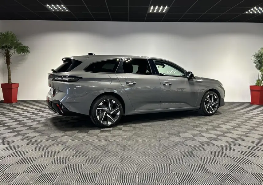 Peugeot 308 SW gris Sélénium vue de profil côté droit, avec jantes alliage 17'' et toit noir brillant.