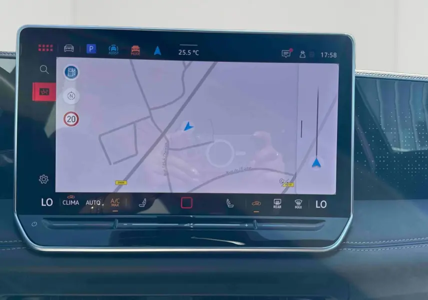 Écran tactile central du Volkswagen Tiguan 2025 affichant la navigation, avec tableau de bord noir et coutures apparentes.