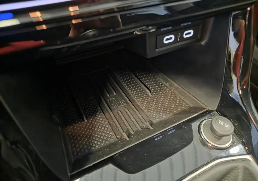 Détail de la console centrale noire avec chargeur à induction et ports USB-C du Volkswagen T-Cross gris.
