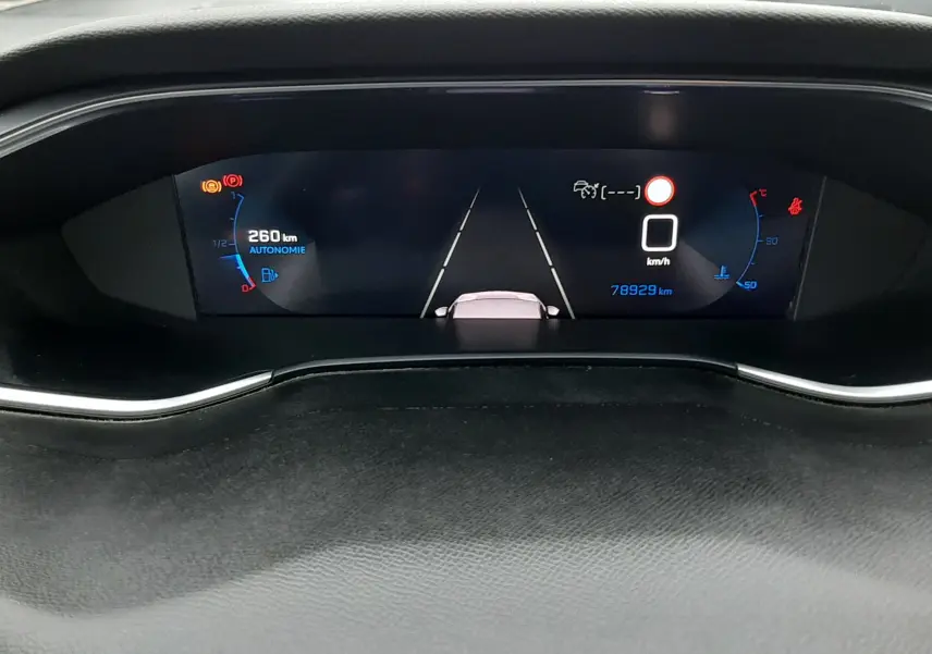 Tableau de bord numérique de Peugeot 308 SW 2021, affichage de l'autonomie et vitesse à 0 km/h, vue frontale rapprochée.