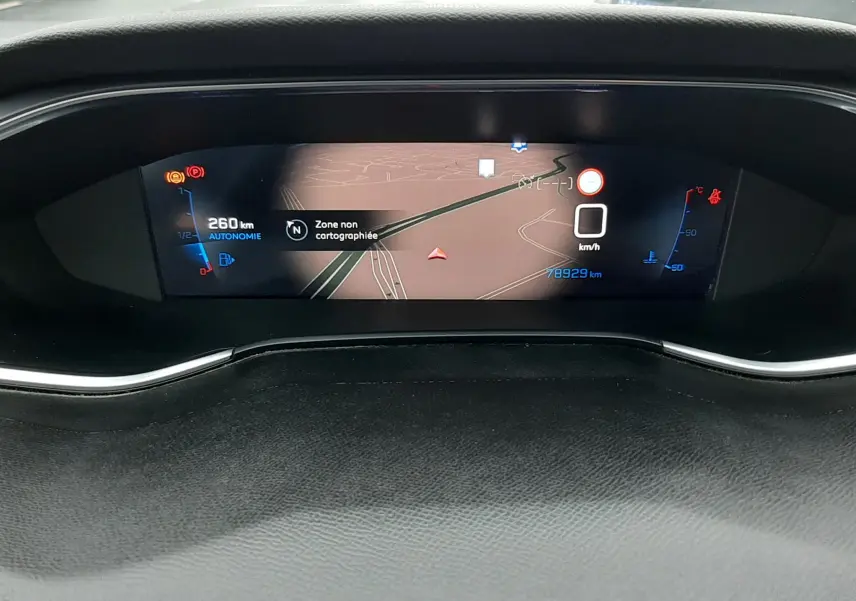 Affichage numérique du tableau de bord de la Peugeot 308 SW 2021, montrant la navigation et l'autonomie restante.